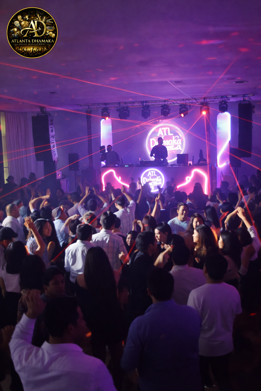 DJ booth and a crowded dance floor under purple and pink lights